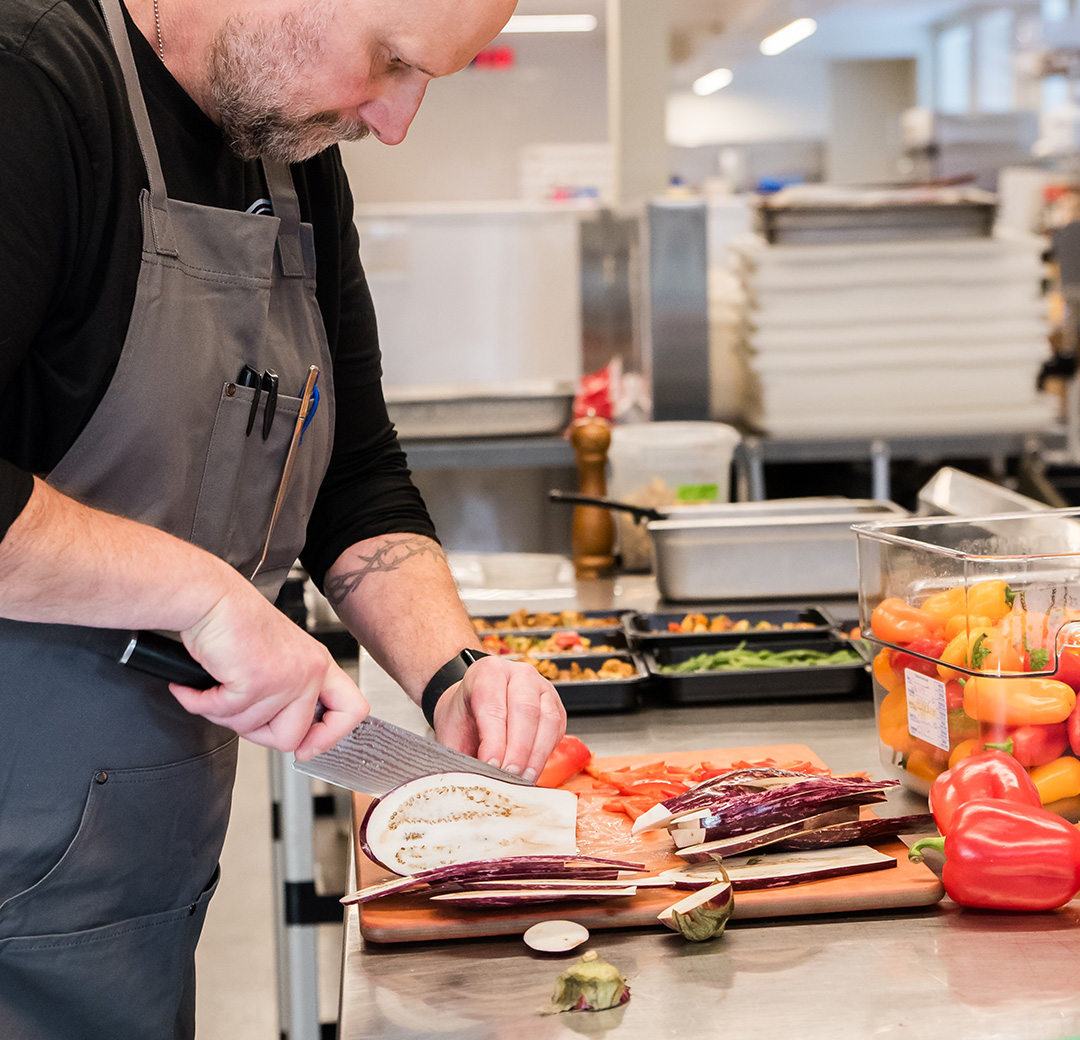Chef preparing vegetables in the shared commercial kitchen at Fulton Commons Pittsburgh